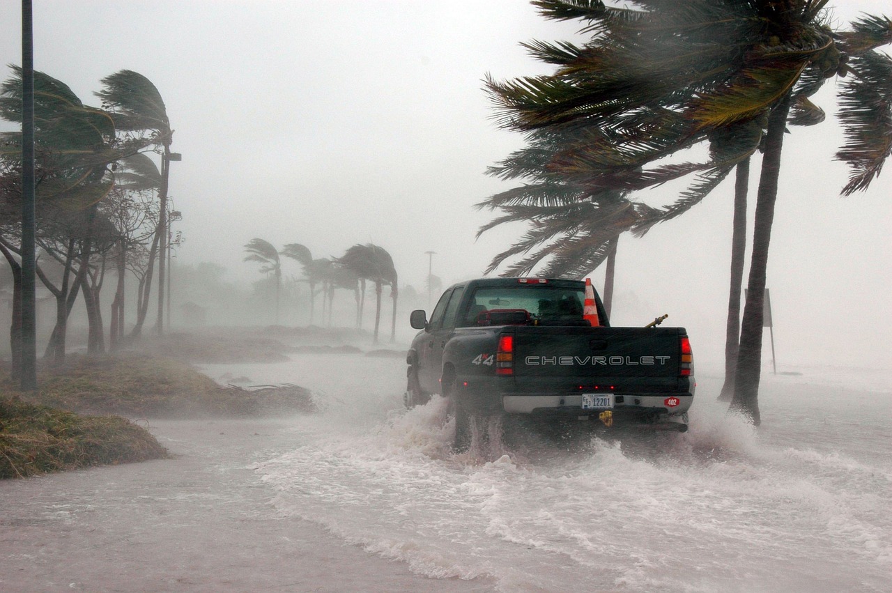 Truck driving along flooded street during a hurricane